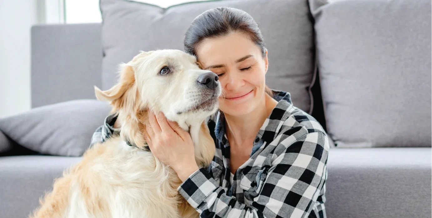 Person with their dog on the sofa at home